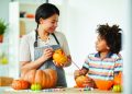 Mom and Boy carving pumpkins