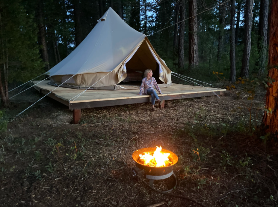 Glamping tent, girl adn campfire