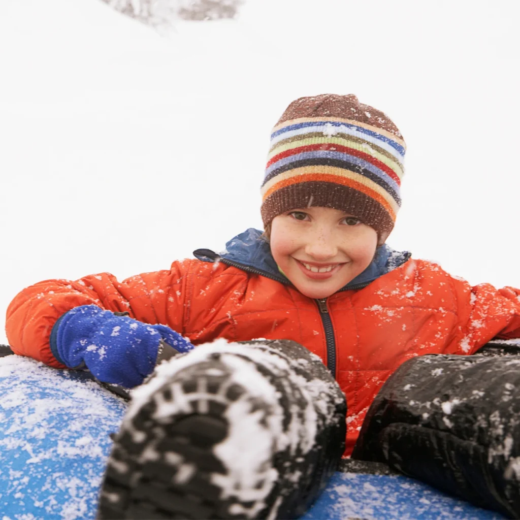Young kid tubing in winter