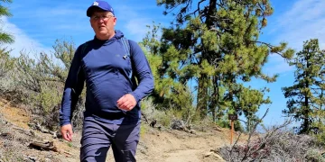 Outdoor Research Hoodie on man on trail